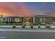 Elegant home boasts professional landscaping, stone accents, and a well-lit path leading to the front door at 19912 E Natalie Way, Queen Creek, AZ 85142