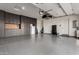 Spacious garage features epoxy flooring, abundant custom cabinets, and well-organized storage solutions at 19912 E Natalie Way, Queen Creek, AZ 85142