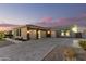Spacious three-car garage featuring a wide driveway and modern design elements enhancing curb appeal at 19912 E Natalie Way, Queen Creek, AZ 85142