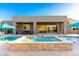 Inviting backyard with a stone hot tub and a blue pool at 19912 E Natalie Way, Queen Creek, AZ 85142