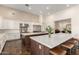 Modern kitchen boasts spacious islands, white cabinets, and stainless steel appliances, perfect for culinary enthusiasts at 19912 E Natalie Way, Queen Creek, AZ 85142
