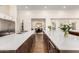 Open-concept kitchen with double islands and ample counter space offers seamless flow to the dining area at 19912 E Natalie Way, Queen Creek, AZ 85142