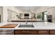 Well-appointed kitchen showcases a large island with sink and stainless steel appliances, creating a functional cooking space at 19912 E Natalie Way, Queen Creek, AZ 85142