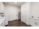 Well-lit laundry room featuring modern appliances, ample white cabinetry, and convenient sink at 19912 E Natalie Way, Queen Creek, AZ 85142