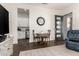 Cozy living area features a dining nook, a statement clock, and seamless access to the kitchen at 19912 E Natalie Way, Queen Creek, AZ 85142