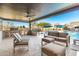 Lovely outdoor kitchen, lounge, and barbecue area by the pool with covered patio at 19912 E Natalie Way, Queen Creek, AZ 85142