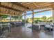 Outdoor lounge area with comfortable seating, a ceiling fan, and view of trees and landscaping at 19912 E Natalie Way, Queen Creek, AZ 85142