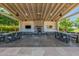 Outdoor patio area with tables, chairs, fireplace, and a mounted television at 19912 E Natalie Way, Queen Creek, AZ 85142