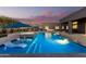 Backyard paradise with a modern pool and spa, sun loungers, water features and patio seating, creating a relaxing outdoor retreat at 19912 E Natalie Way, Queen Creek, AZ 85142