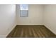 A simple bedroom with light walls, carpet flooring, and a bright window with modern blinds at 2061 W Burnside Trl, Phoenix, AZ 85085