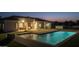 Backyard with a pool and a covered stone fireplace, as well as professional landscaping at 21442 E Excelsior Ave, Queen Creek, AZ 85142