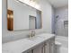 Bathroom with white marble countertops and a bronze-framed mirror at 21442 E Excelsior Ave, Queen Creek, AZ 85142