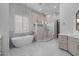 Bright bathroom featuring a soaking tub and glass enclosed shower at 21442 E Excelsior Ave, Queen Creek, AZ 85142