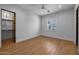 Bright bedroom with a ceiling fan, hardwood floors, closet, and natural light from the window at 21442 E Excelsior Ave, Queen Creek, AZ 85142