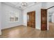 Bedroom with a large window, coffered ceilings, and dark wooden doors at 21442 E Excelsior Ave, Queen Creek, AZ 85142
