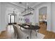 A stylish dining room is showcased with modern lighting and seating for six at 21442 E Excelsior Ave, Queen Creek, AZ 85142