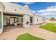 The covered patio has a stone fireplace and overlooks the backyard and pool at 21442 E Excelsior Ave, Queen Creek, AZ 85142