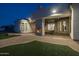 Exterior view of a home with a covered outdoor patio, stone fireplace, and pavers at 21442 E Excelsior Ave, Queen Creek, AZ 85142