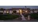 A beautiful single-story home exterior showcases professional landscaping and stunning stone details at 21442 E Excelsior Ave, Queen Creek, AZ 85142