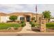 Beautiful single-story home with lush landscaping, a stone-accented entryway, and a welcoming walkway at 21442 E Excelsior Ave, Queen Creek, AZ 85142