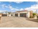 A detached 3-car garage with dark wood doors with a long driveway and basketball court at 21442 E Excelsior Ave, Queen Creek, AZ 85142