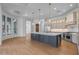 A spacious kitchen featuring stainless steel appliances, quartz countertops, and custom cabinets at 21442 E Excelsior Ave, Queen Creek, AZ 85142