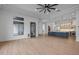 Spacious living room with sleek ceiling fan, wood-look floors, and modern design at 21442 E Excelsior Ave, Queen Creek, AZ 85142