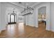 An elegant dining room showcases chandeliers and arched doorways at 21442 E Excelsior Ave, Queen Creek, AZ 85142