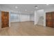 Spacious living room with hardwood floors, a staircase, and two wood doors at 21442 E Excelsior Ave, Queen Creek, AZ 85142