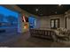 Outdoor living space with a stone fireplace and comfortable seating area overlooking the pool at 21442 E Excelsior Ave, Queen Creek, AZ 85142