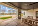 An outdoor fireplace overlooks the pool and backyard for relaxed outdoor living at 21442 E Excelsior Ave, Queen Creek, AZ 85142