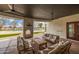 An outdoor living area features a fireplace, multiple ceiling fans, and plenty of seating at 21442 E Excelsior Ave, Queen Creek, AZ 85142
