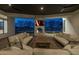 Outdoor living space with a stone fireplace, TV, and comfortable seating area overlooking the pool at 21442 E Excelsior Ave, Queen Creek, AZ 85142