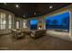 A covered patio features an outdoor fireplace, comfortable seating, and ceiling fans at 21442 E Excelsior Ave, Queen Creek, AZ 85142