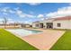 A backyard featuring a sparkling pool and a well-manicured lawn, complemented by a modern home design at 21442 E Excelsior Ave, Queen Creek, AZ 85142