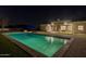Backyard view with pool, patio, and stone fireplace on an immaculately maintained lawn at 21442 E Excelsior Ave, Queen Creek, AZ 85142
