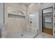 Modern tiled walk in shower with bench and glass door at 21442 E Excelsior Ave, Queen Creek, AZ 85142