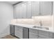 A modern wet bar with white cabinets and stainless-steel appliances at 21442 E Excelsior Ave, Queen Creek, AZ 85142