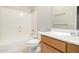 Clean bathroom features a tub/shower combo with a white surround and a wood vanity at 227 E Carob Dr, Chandler, AZ 85286