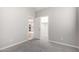 Carpeted bedroom featuring a large closet and an open door to the kitchen at 227 E Carob Dr, Chandler, AZ 85286