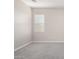 Empty bedroom showcasing carpeted floors and a window with blinds at 227 E Carob Dr, Chandler, AZ 85286