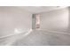 Bedroom with carpet, neutral walls, and an open door leading to bathroom at 227 E Carob Dr, Chandler, AZ 85286
