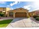 Charming single-story home featuring a two-car garage, desert landscaping and a welcoming facade at 227 E Carob Dr, Chandler, AZ 85286