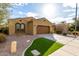 Lovely tan home featuring desert landscaping and an attached two-car garage at 227 E Carob Dr, Chandler, AZ 85286
