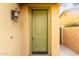 Inviting front door with decorative lighting and neutral exterior paint at 227 E Carob Dr, Chandler, AZ 85286