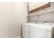 A well-equipped laundry room with modern appliances and convenient shelving at 227 E Carob Dr, Chandler, AZ 85286