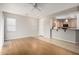 Open-concept living room with wood floors, a ceiling fan, and a view of the kitchen at 227 E Carob Dr, Chandler, AZ 85286