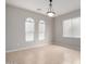 Bright and airy living space with neutral tile flooring and multiple windows at 227 E Carob Dr, Chandler, AZ 85286