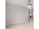 Open area with neutral tile flooring, chandelier, and doorway at 227 E Carob Dr, Chandler, AZ 85286