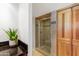 Modern bathroom featuring a glass-enclosed shower with tiled walls and a wood door at 2323 N Central Ave # 1902, Phoenix, AZ 85004